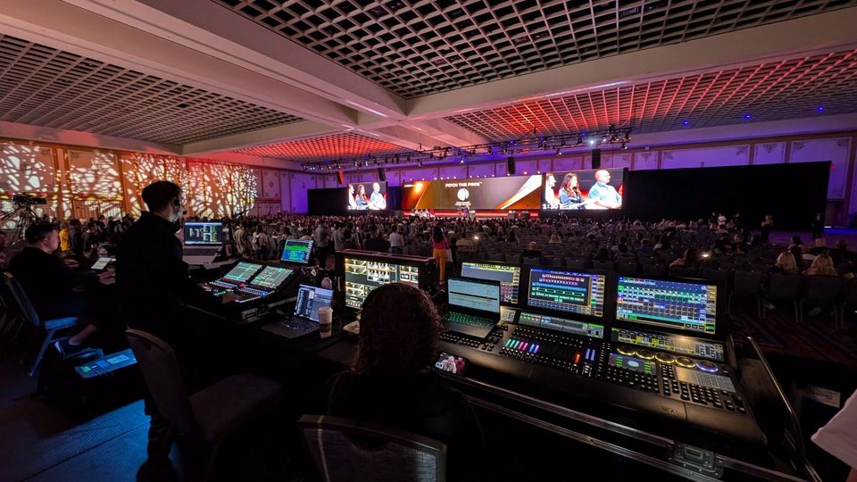 Front of house at CoCreate — video and lighting desks with the pitch stage beyond