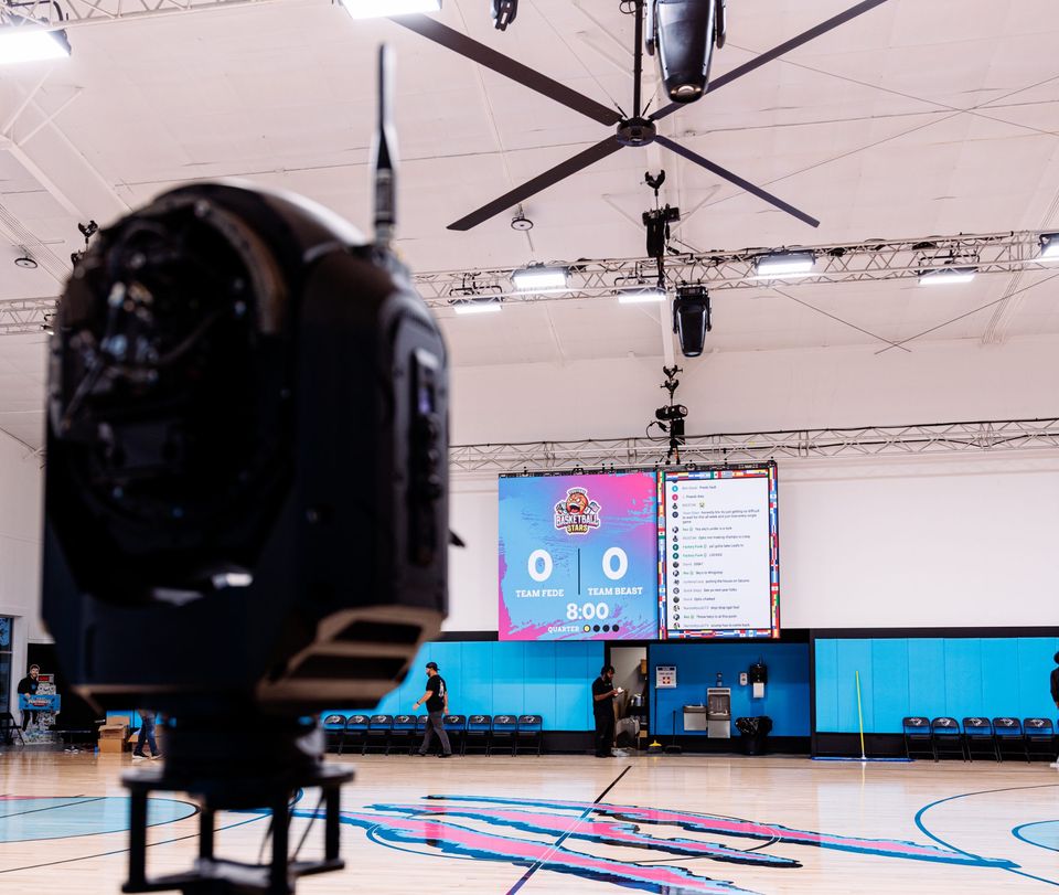 Broadcast camera facing the Beast Arena scoreboard before the MrBeast vs. Fede basketball livestream