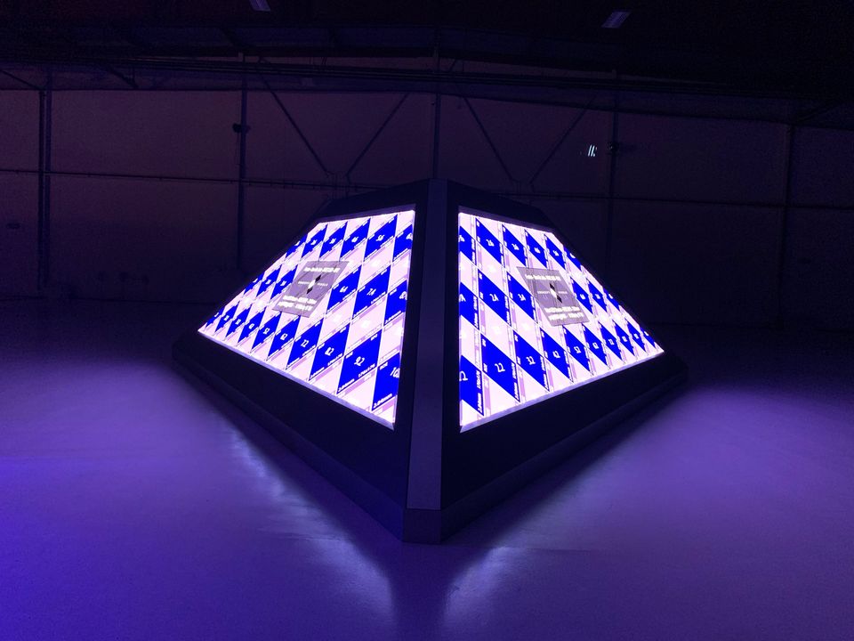 The pyramid lit with a checkered pattern, seen from the floor