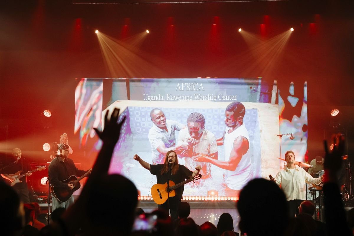 Baptism footage from Africa on the GP2 wall behind the band while the theater worships