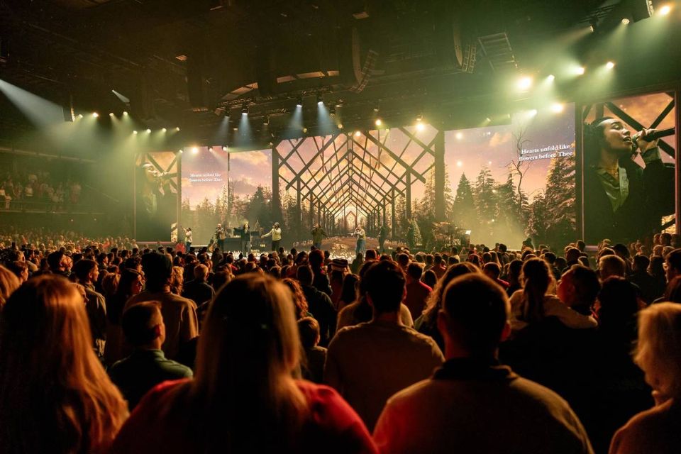 A warm cabin-in-the-forest environment with the congregation in the room