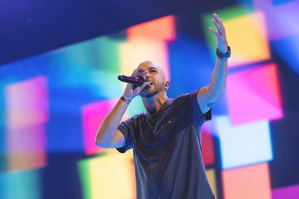 A worship leader on the Wonderwall with colored panels across the LED behind him