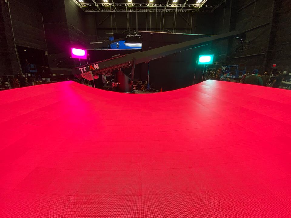 The curved red LED floor for Levitating, lit in the studio before the shoot