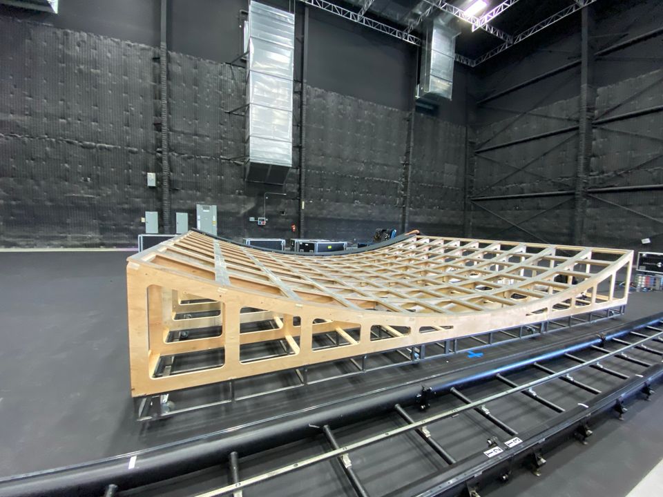 The timber sub-structure that carries the curve of the LED floor