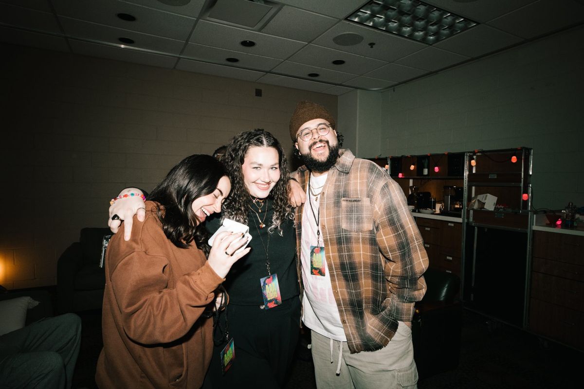 Crew embracing backstage after a show