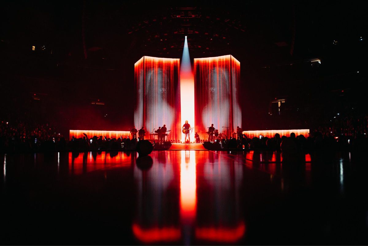 Brandon Lake on the King of Hearts stage, full red LED wall reflected on the floor