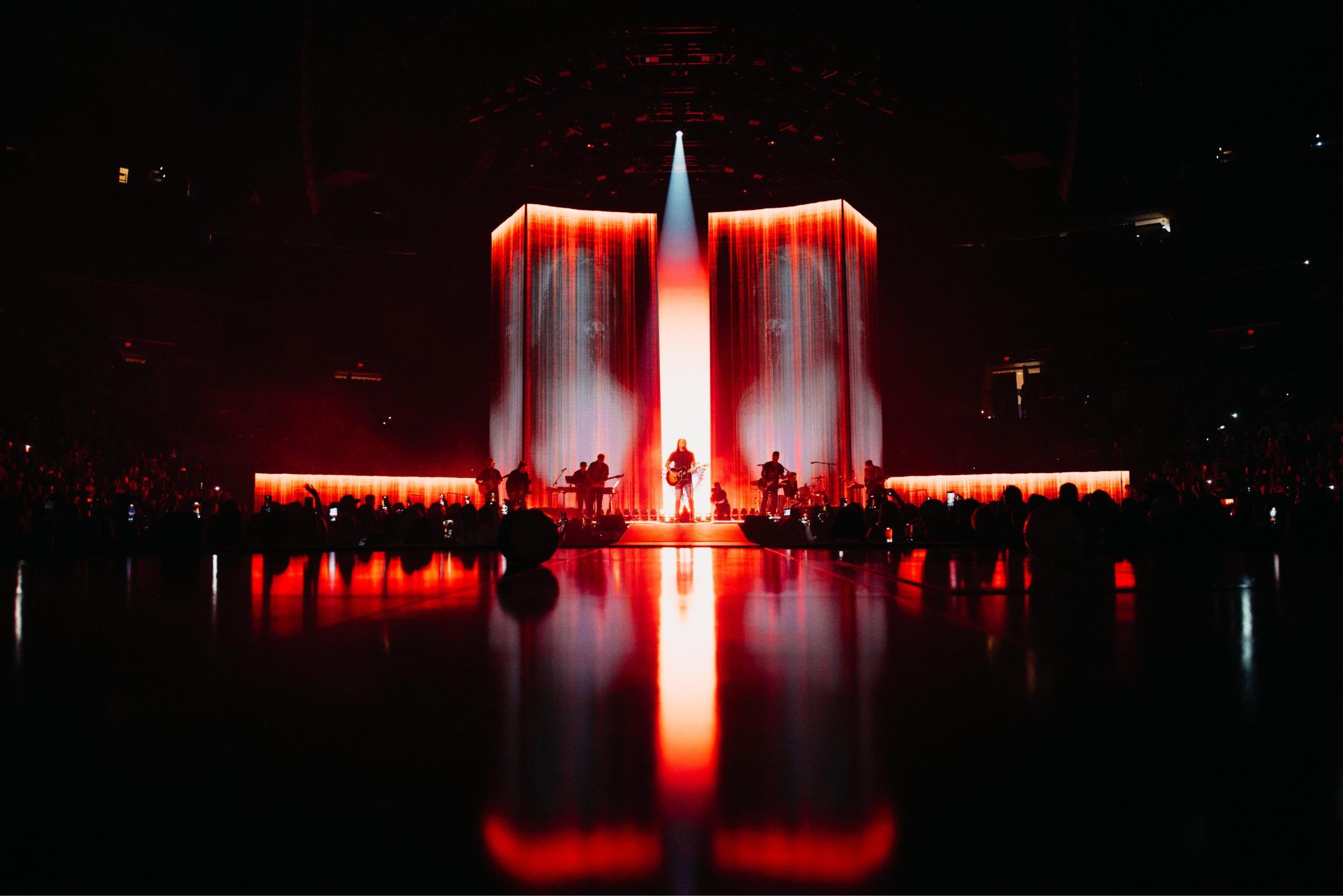 Brandon Lake on the King of Hearts stage, full red LED wall reflected on the floor