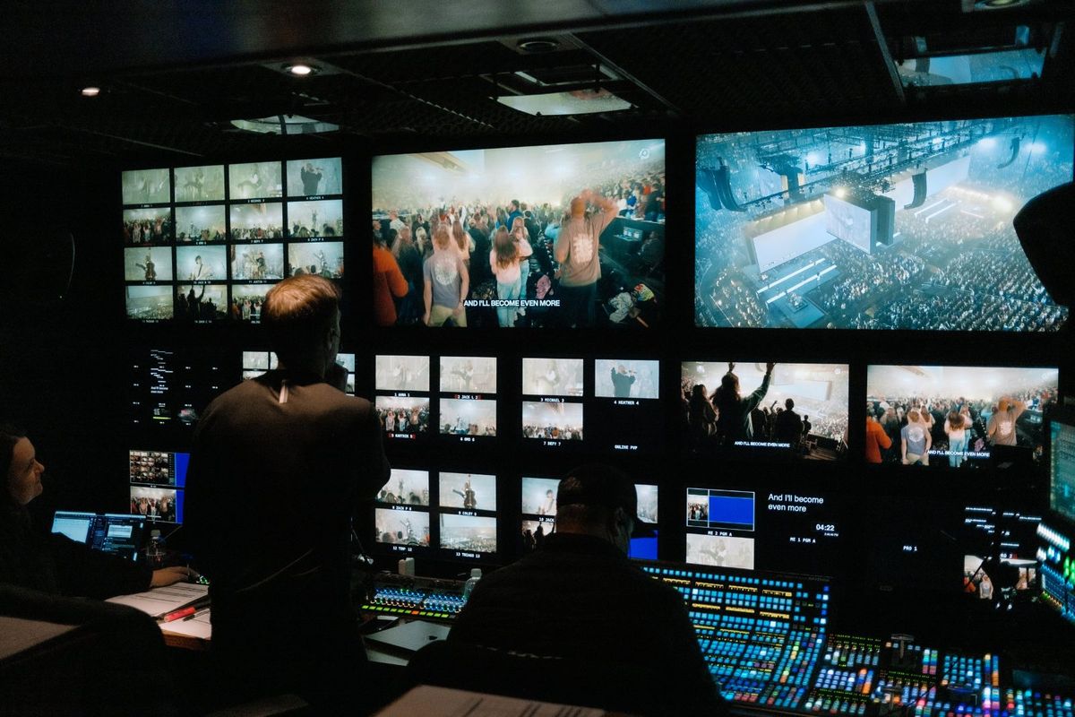 The broadcast control room at Passion 2025 — camera ISOs across the multiviewer, lyrics on program