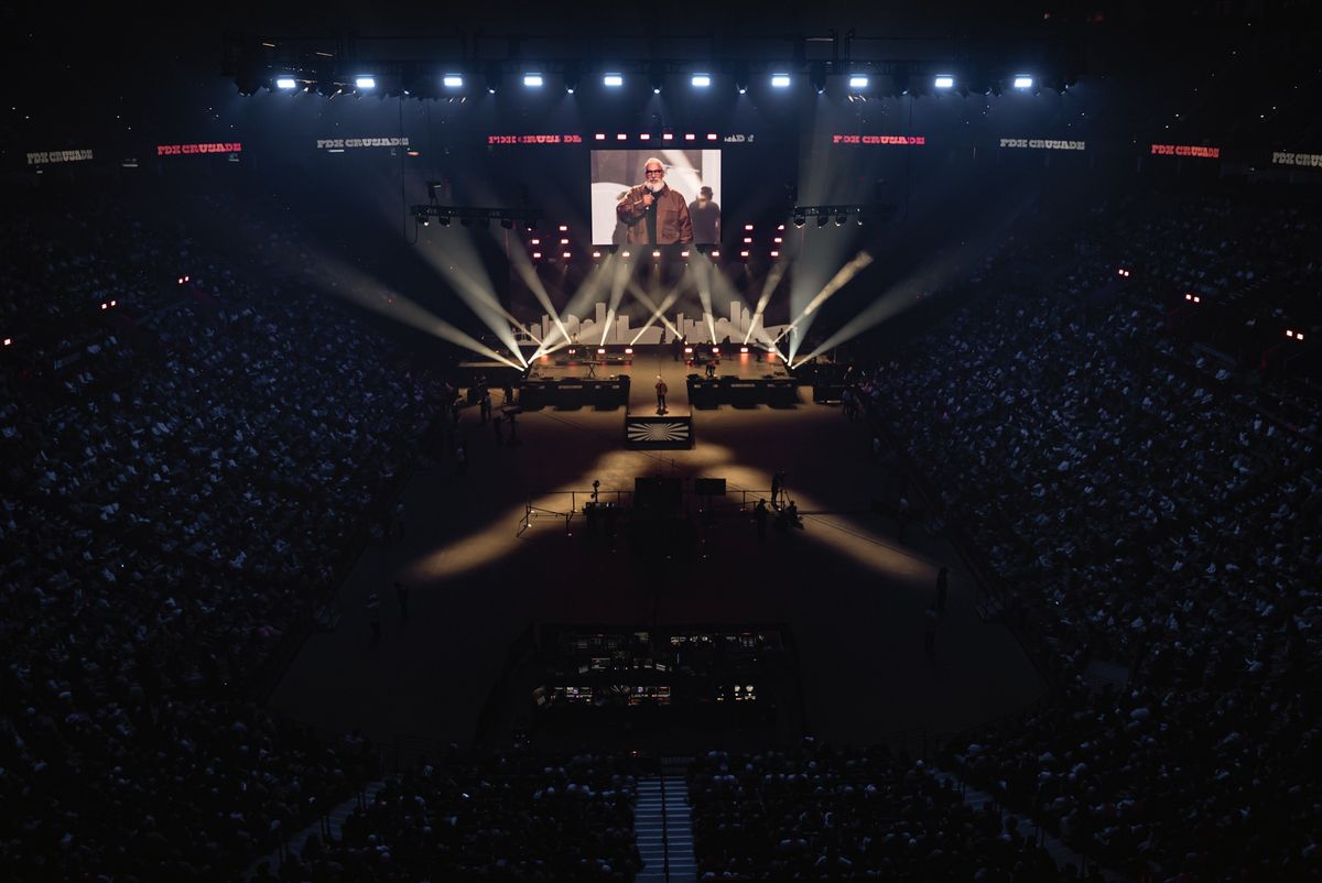 The PDX Crusade stage from front of house — the GP2 upstage wall flanked by the CB8 channel walls, the lighting rig above, the arena floor full